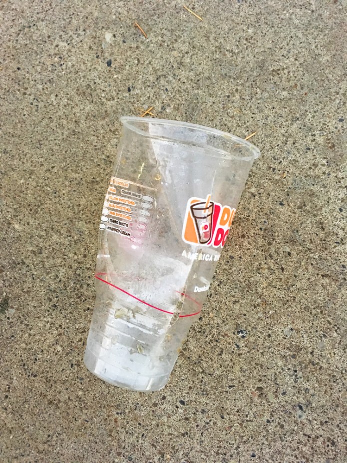 Dunkin' Donuts cup on the sidewalk (not staged or rearranged).